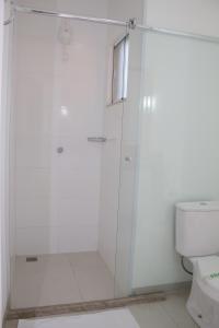 a bathroom with a shower and a toilet at Hotel e Pousada Bem Bom - Itu in Itu