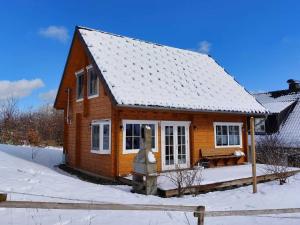 una pequeña casa de madera con nieve en el suelo en Home in Wissinghausen with Private Sauna, en Medebach