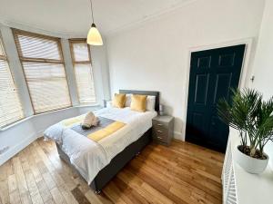 a bedroom with a bed and a potted plant at Liverpool Getaway Home! in Liverpool