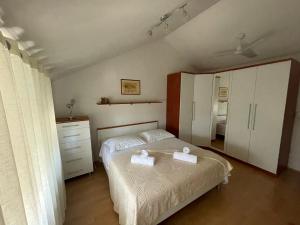 a bedroom with a bed with two towels on it at Jacuzzi apartman Marin in Bol