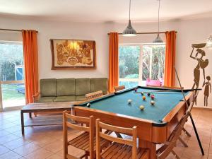 a living room with a pool table and a couch at Private Villa Rego with Oceanview and Pool in Luz