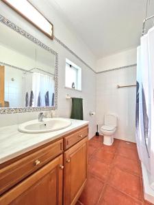 a bathroom with a sink and a toilet at Private Villa Rego with Oceanview and Pool in Luz