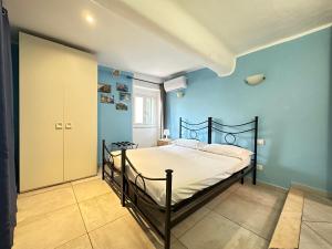 een slaapkamer met een bed in een blauwe kamer bij Appartamenti a Cà Mia in La Spezia