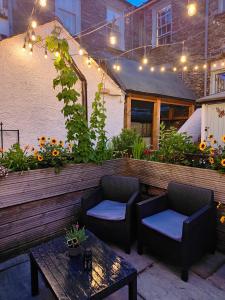 a patio with two chairs and a table and lights at The Elleray in Windermere