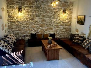 a living room with a couch and a coffee table at Cretan House Antonis in Kamilari