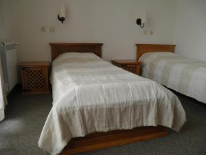 a bedroom with two beds and two night stands at Pripetzite Hotel in Godlevo