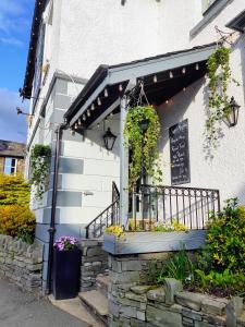 a building with a balcony with flowers on it at The Elleray in Windermere