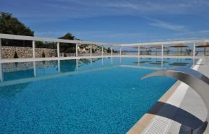 a swimming pool with blue water in a resort at Maja Vita _ Maja in Drage