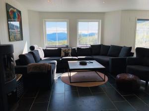 a living room with a couch and a table at Grand and modern cabin in Sogndal