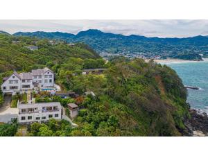 a house on a hill next to the ocean at Garden Villa Shirahama - Vacation STAY 59275v in Shimoda