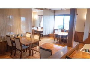 a dining room with wooden tables and chairs at Garden Villa Shirahama - Vacation STAY 59275v in Shimoda