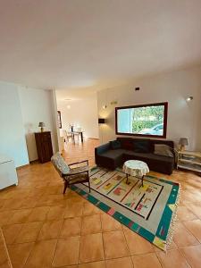 a living room with a couch and a flat screen tv at Villa delle Magnolie Montesilvano Abruzzo in Montesilvano