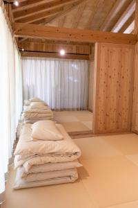 a room with a row of pillows on the floor at SHINMINKA Villa JANADO - Vacation STAY 66320v in Kumejima