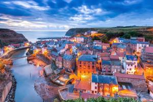 an aerial view of a town next to the water at The Blue Porch Staithes in Staithes