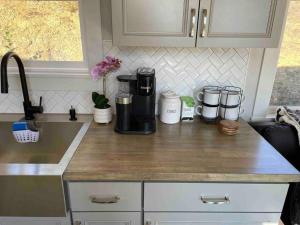 a kitchen counter with a coffee maker on it at Delightful Tiny Home w/ 2 beds and indoor fireplace in McKinleyville