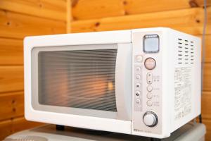 a white microwave oven sitting on top of a table at Yokkaichi - House - Vacation STAY 68045v in Yokkaichi