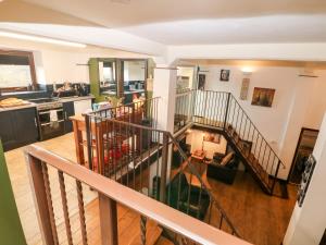 a living room and kitchen with a spiral staircase in a house at Cambridge Lodge in Matlock