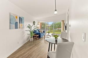 a living room with a table and a dining room at The Concord Place in Peoria