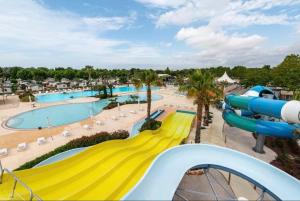 a slide at a water park with a pool at Mobilhome 5 VO32 in Vias