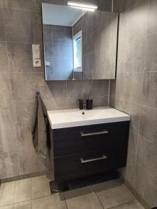 a bathroom with a sink and a mirror at Reinebu in Ørsta
