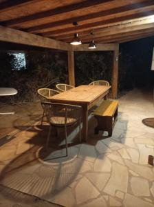 a wooden table and chairs on a patio at Fischerhaus 1950 in Le Barcarès