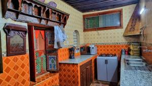 a kitchen with a stove and a sink in it at Dar La Bague de Kenza in Fez