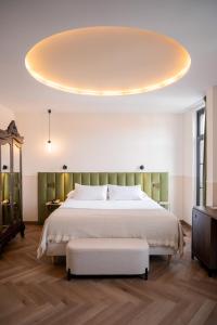 a bedroom with a large bed with a large ceiling at Hotel Boutique Las Indianas in Nueva de Llanes