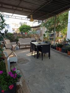 a patio with a black table and chairs and flowers at Best Location in Bodrum Center in Bodrum City