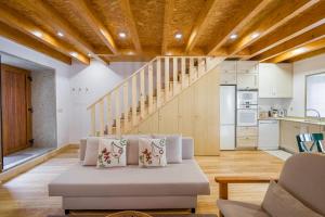 a living room with a couch and a staircase at Casa do Rego in Melgaço