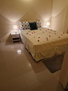 a bedroom with a bed with red roses on it at My Gem in the Caribbean in Castries