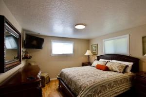 a bedroom with a bed and a television in it at Centrally Located Redmond Retreat with Pool Table in Redmond