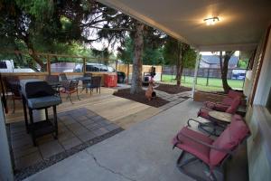 a covered patio with chairs and a table and a fire hydrant at Centrally Located Redmond Retreat with Pool Table in Redmond