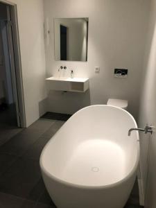 a bathroom with a white toilet and a sink at Storlauvøya The Atlantic Ocean Road in Karvåg +32 photos