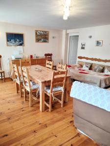 a dining room with a table and chairs and a bed at Gite Notre Désir in Abriès