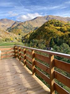 a wooden boardwalk with a view of a mountain at Chalet Vue Montagne 6 personnes proche Sanctuaire de La Salette in La Salette-Fallavaux