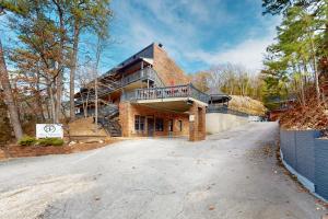 a large brick house with a balcony on a driveway at Bella Paradiso 12 in Eureka Springs