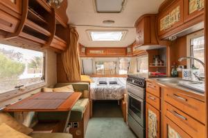 an rv kitchen with a table and a sink at Villaverde Glamping in Villaverde