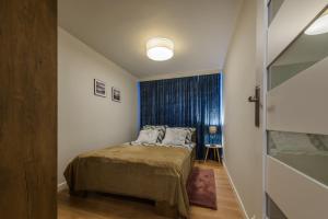mała sypialnia z łóżkiem i oknem w obiekcie Apartament Pod Dwójką w Bielsku Białej