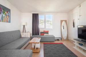 a living room with a couch and a tv at Central, Cozy, Comfy, 1BR House, Free Parking & Fast Wi-Fi, 4ppl in Bodrum City