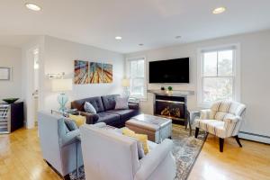 a living room with a couch and a fireplace at Beech Tree Retreat in Provincetown