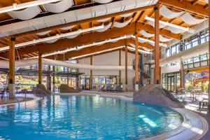 a large swimming pool in a building with a large building at Sunriver Resort in Sunriver