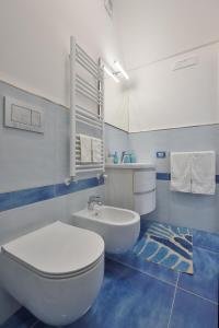 a bathroom with a white toilet and a sink at Amalfi Sea View in Scala