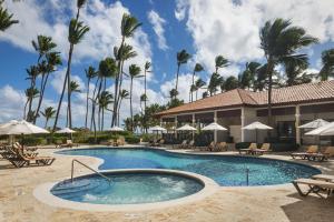 a pool at a resort with palm trees at Jewel Palm Beach in Punta Cana