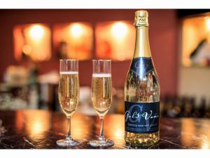 平冢市太阳花园酒店的桌上有一瓶香槟和两个酒杯