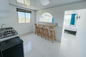 a white kitchen with a stove and a counter top at Apartamentos Chalet del Mar in San Andrés