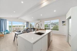 a kitchen and living room with a view of a living room at Timeout @ Taupo - Lake Views in Taupo