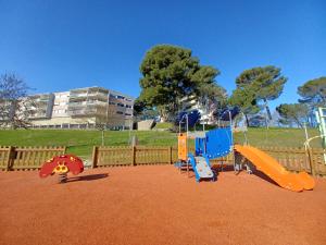 a playground with three slides at Two bedrooms modern apartment close to Tram in Toulouse