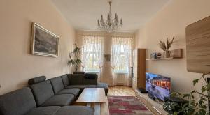 a living room with a couch and a tv at Apartment Bohemia in Karlovy Vary