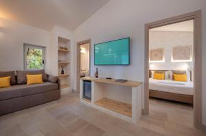A bed or beds in a room at Gattarella Family Resort Puglia- Seaside Rooms and Suites with Premium Half-Board à la carte
