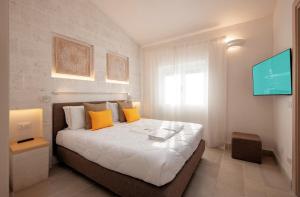 A bed or beds in a room at Gattarella Family Resort Puglia- Seaside Rooms and Suites with Premium Half-Board à la carte